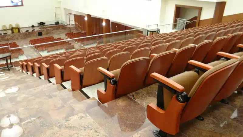 Rows of tan upholstered auditorium seats in a church sanctuary in Kansas Rows of tan upholstered auditorium seats in a church sanctuary in Kansas