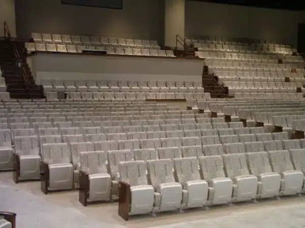 Rows of light-colored upholstered auditorium chairs at First Church in Kokomo Indiana Rows of light-colored upholstered auditorium chairs at First Church in Kokomo Indiana