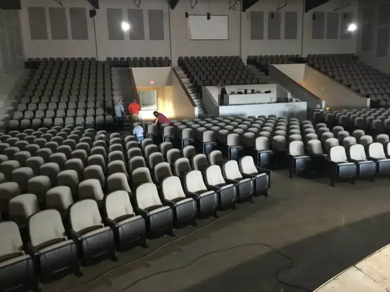 Workers checking rows of gray and black upholstered auditorium seating during installation at Lifeway Church Workers checking rows of gray and black upholstered auditorium seating during installation at Lifeway Church